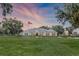 Charming single-story home with American flag, well manicured lawn and mature trees at 5478 Nw 153Rd Ct, Morriston, FL 32668