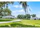 Idyllic property featuring a long driveway, and additional building, complemented by well-manicured lawns and mature shade trees at 5478 Nw 153Rd Ct, Morriston, FL 32668