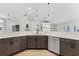 Open kitchen with sleek countertops, modern cabinets, stainless steel appliances, and pendant lighting at 5478 Nw 153Rd Ct, Morriston, FL 32668