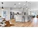 Bright kitchen features white cabinets, a large island with seating, and stainless steel appliances at 5478 Nw 153Rd Ct, Morriston, FL 32668