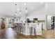 Bright kitchen features white cabinets, stainless steel appliances, stone backsplash, and breakfast bar with pendant lighting at 5478 Nw 153Rd Ct, Morriston, FL 32668