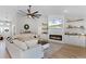 Bright living room featuring a cozy fireplace, modern furnishings, and large screen tv at 5478 Nw 153Rd Ct, Morriston, FL 32668