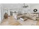 Spacious open-concept living room with stylish furnishings, modern lighting, and seamless kitchen integration at 5478 Nw 153Rd Ct, Morriston, FL 32668
