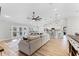 Open concept living room with modern decor, ceiling fan, and pendant lights overlooking the kitchen at 5478 Nw 153Rd Ct, Morriston, FL 32668