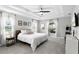 Bright main bedroom featuring a tray ceiling, ceiling fan, and two windows with natural light at 5478 Nw 153Rd Ct, Morriston, FL 32668