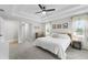 Bright main bedroom with a ceiling fan, neutral walls, soft carpet, and two windows with natural light at 5478 Nw 153Rd Ct, Morriston, FL 32668