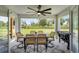 Outdoor patio with dining area, ceiling fan, grill, and serene backyard views at 5478 Nw 153Rd Ct, Morriston, FL 32668