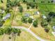Aerial shot outlining property with green pastures, trees, and long driveway at 5478 Nw 153Rd Ct, Morriston, FL 32668
