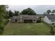 Beautiful home with fenced yard featuring mature trees, a screened patio, and lush lawn for outdoor enjoyment at 6047 Shore Line Dr, Orlando, FL 32819