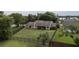 An aerial shot features a fenced in backyard with green grass surrounding the property at 6047 Shore Line Dr, Orlando, FL 32819