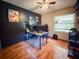 Bedroom with hardwood floors, a ceiling fan, and a desk area at 6047 Shore Line Dr, Orlando, FL 32819