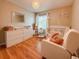 Warm and inviting Bedroom featuring a crib, dresser, and cozy chair at 6047 Shore Line Dr, Orlando, FL 32819