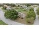 Aerial view of a home with a well-maintained lawn and mature trees at 6047 Shore Line Dr, Orlando, FL 32819