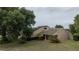 Aerial view of home with well-maintained lawn and mature trees at 6047 Shore Line Dr, Orlando, FL 32819