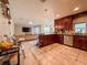 Open concept kitchen featuring dark wood cabinetry, granite countertops, and tile flooring, ideal for modern living at 6047 Shore Line Dr, Orlando, FL 32819