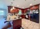 Updated kitchen features dark wood cabinetry, granite countertops, and a breakfast bar, perfect for casual dining at 6047 Shore Line Dr, Orlando, FL 32819