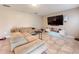 Comfortable living area features tile flooring, a large TV, and a neutral color palette for a relaxing atmosphere at 6047 Shore Line Dr, Orlando, FL 32819