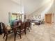 Open-concept living space featuring a dining area, brick fireplace, and large windows that provide plenty of natural light at 6047 Shore Line Dr, Orlando, FL 32819