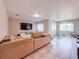 Spacious living area features tile flooring, a large TV, and plenty of natural light, perfect for Gathering gatherings at 6047 Shore Line Dr, Orlando, FL 32819