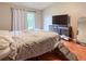 Spacious main bedroom featuring hardwood floors, a modern dresser, and a large window for natural light at 6047 Shore Line Dr, Orlando, FL 32819