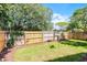 Enjoy the private backyard with its tall wood fence, lush green lawn, and mature landscaping at 631 Warrenton Rd, Winter Park, FL 32792