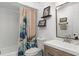 Bathroom featuring a single vanity, shower-tub combo, and neutral color palette at 631 Warrenton Rd, Winter Park, FL 32792