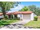 Charming single-story home featuring a tile roof, manicured lawn, and two-car garage at 631 Warrenton Rd, Winter Park, FL 32792