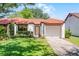 Charming single-story home featuring a red tile roof and a well-manicured front lawn at 631 Warrenton Rd, Winter Park, FL 32792