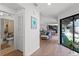 Bright hallway showcases hardwood floors, leading to a living area with lots of natural light at 631 Warrenton Rd, Winter Park, FL 32792
