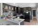 Modern kitchen boasts black cabinetry, a stylish backsplash, and stainless steel appliances at 631 Warrenton Rd, Winter Park, FL 32792