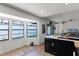Bright kitchen featuring an island, black appliances, and large windows at 631 Warrenton Rd, Winter Park, FL 32792