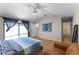 Bright main bedroom featuring light wood floors, vaulted ceilings, slider to outside patio, and ensuite bath at 631 Warrenton Rd, Winter Park, FL 32792