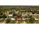 Aerial view of a quaint single-story home with a well-maintained lawn surrounded by lush greenery and neighboring houses at 826 Cherokee Cir, Sanford, FL 32773
