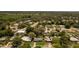 Aerial showing the property, neighborhood homes, and nearby pool within a lush, green environment at 826 Cherokee Cir, Sanford, FL 32773