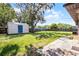 Spacious backyard with a shed, lush lawn, and mature trees providing shade at 826 Cherokee Cir, Sanford, FL 32773