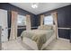 Cozy bedroom with a comfortable bed, tile floors, and colorful floral curtains at 826 Cherokee Cir, Sanford, FL 32773