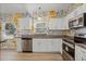Kitchen with stainless steel appliances, granite countertops, and lovely floral wallpaper accent wall at 826 Cherokee Cir, Sanford, FL 32773
