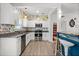 Well-lit kitchen featuring stainless steel appliances, granite countertops, and vibrant floral wallpaper at 826 Cherokee Cir, Sanford, FL 32773