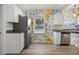 Kitchen showcasing granite counters, stainless appliances, white cabinetry, and floral wallpaper accents at 826 Cherokee Cir, Sanford, FL 32773