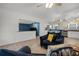 Bright open living room featuring modern flooring, colorful wallpaper, and cozy seating area at 826 Cherokee Cir, Sanford, FL 32773