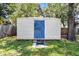Neutral shed in backyard with dark blue door, providing extra outdoor storage space at 826 Cherokee Cir, Sanford, FL 32773
