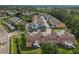 Wide aerial showcasing a neighborhood with colorful buildings, parking areas, and a well-maintained landscape at 8704 Knightsbridge Ct # B, Kissimmee, FL 34747