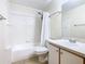 Clean bathroom featuring a shower-tub combo, updated fixtures, and a vanity with storage at 8704 Knightsbridge Ct # B, Kissimmee, FL 34747