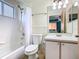 This bathroom has a shower-tub combination, white sink and cabinets, and large mirror at 8704 Knightsbridge Ct # B, Kissimmee, FL 34747