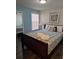 Comfortable bedroom with wood floors, mirrored closet, window and a queen size bed at 8704 Knightsbridge Ct # B, Kissimmee, FL 34747