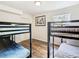 Shared bedroom featuring two sets of bunk beds and wood-look flooring at 8704 Knightsbridge Ct # B, Kissimmee, FL 34747