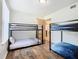 Shared bedroom featuring two sets of bunk beds and wood-look flooring at 8704 Knightsbridge Ct # B, Kissimmee, FL 34747