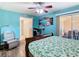 Comfortable bedroom has an attached workspace, recliner, and access to an outdoor patio at 8704 Knightsbridge Ct # B, Kissimmee, FL 34747