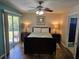Cozy bedroom with wood floors, ceiling fan, and sliding glass door to a private patio at 8704 Knightsbridge Ct # B, Kissimmee, FL 34747