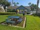 Inviting clubhouse with picnic table, grill, and manicured lawn at 8704 Knightsbridge Ct # B, Kissimmee, FL 34747